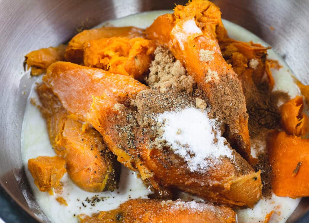 cooked sweet potatoes with coconut milk, and spices in bowl