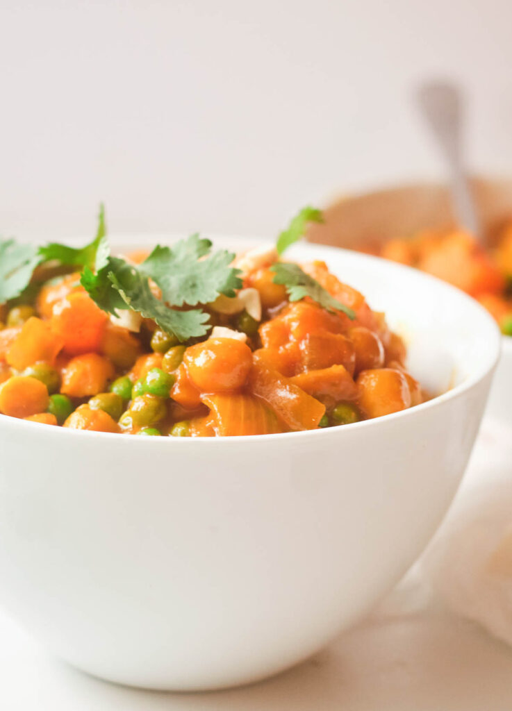 butternut squash and chickpea curry topped with cilantro and cashews