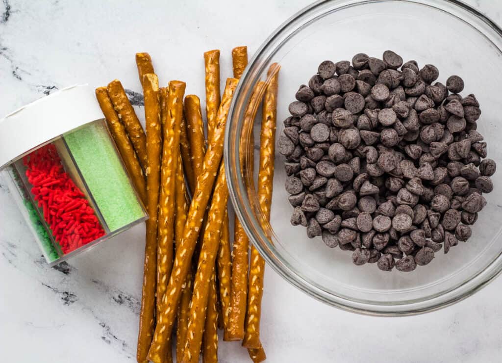 chocolate chips, pretzel rods, and holiday sprinkles