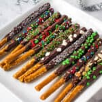 chocolate pretzel rods on white plate