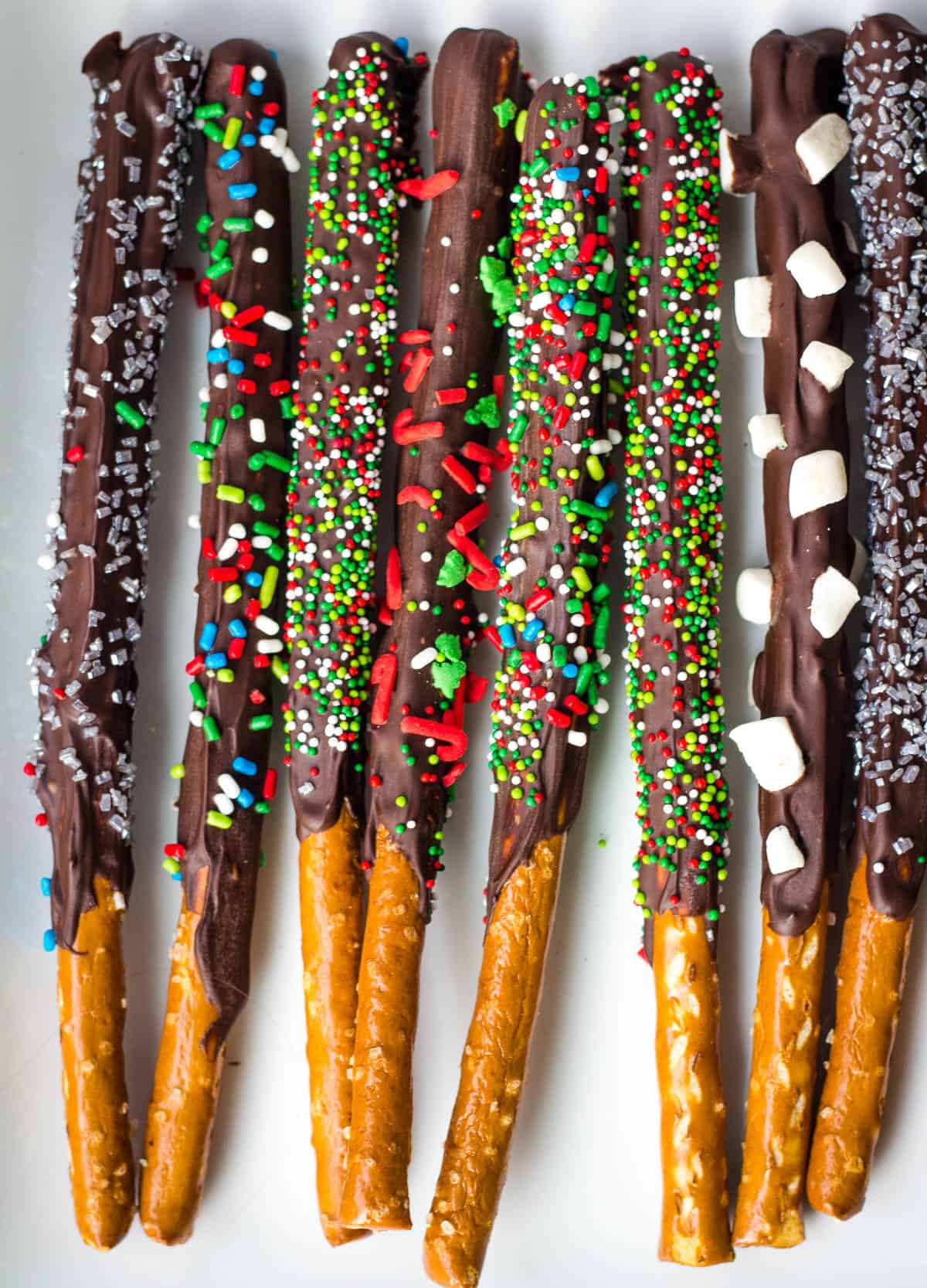 chocolate covered pretzel rods with holiday sprinkles