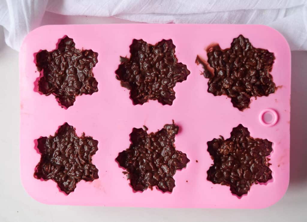 snowflake molds willed with chocolate and rice cereal
