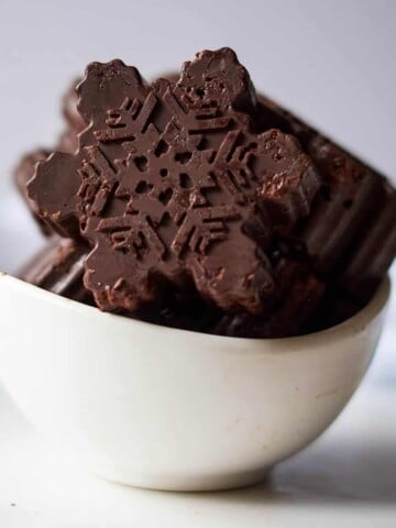 dark chocolate snowflakes in white bowl