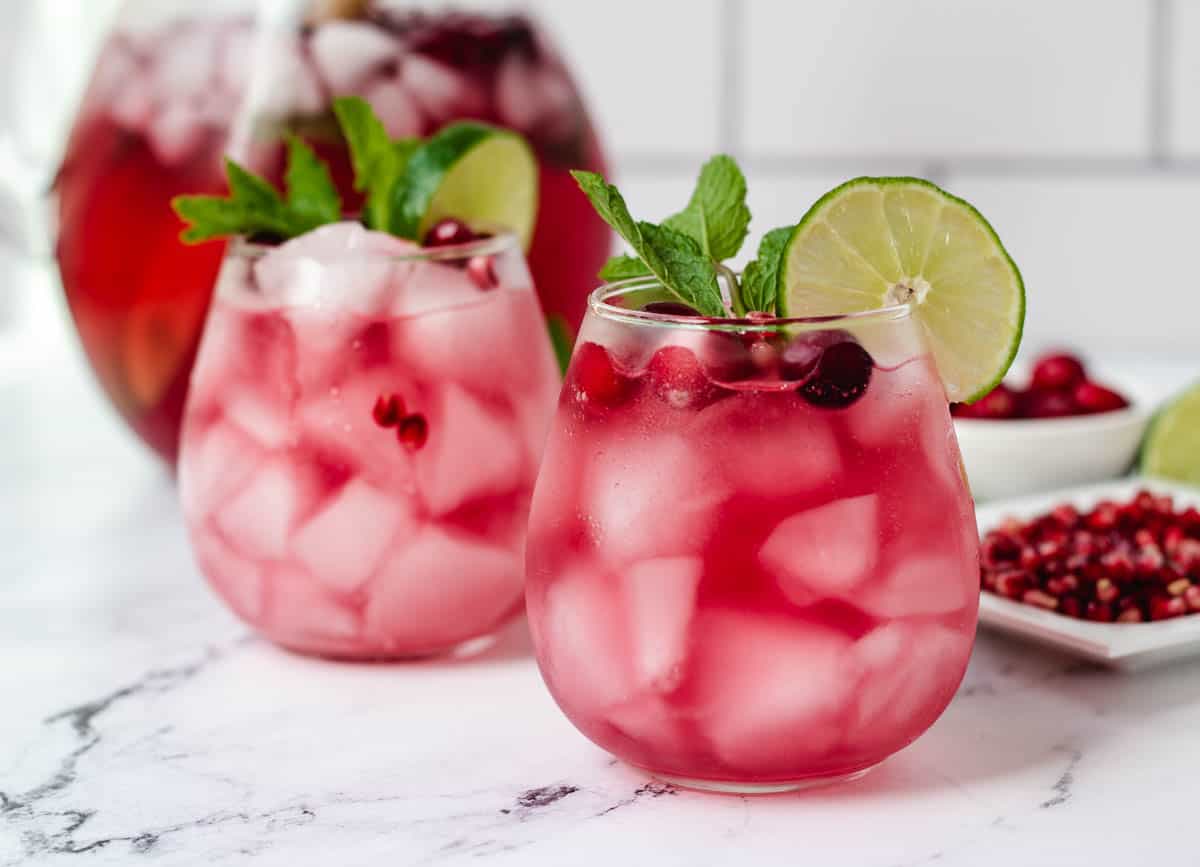 two cranberry mocktails garnished with lime and mint