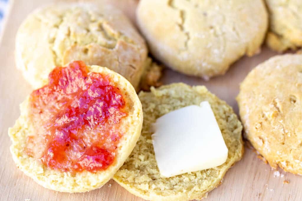 opened dairy-free biscuit with jam and butter