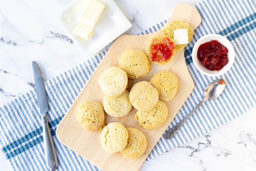 dairy free biscuits on wood serving tray with jam and butter