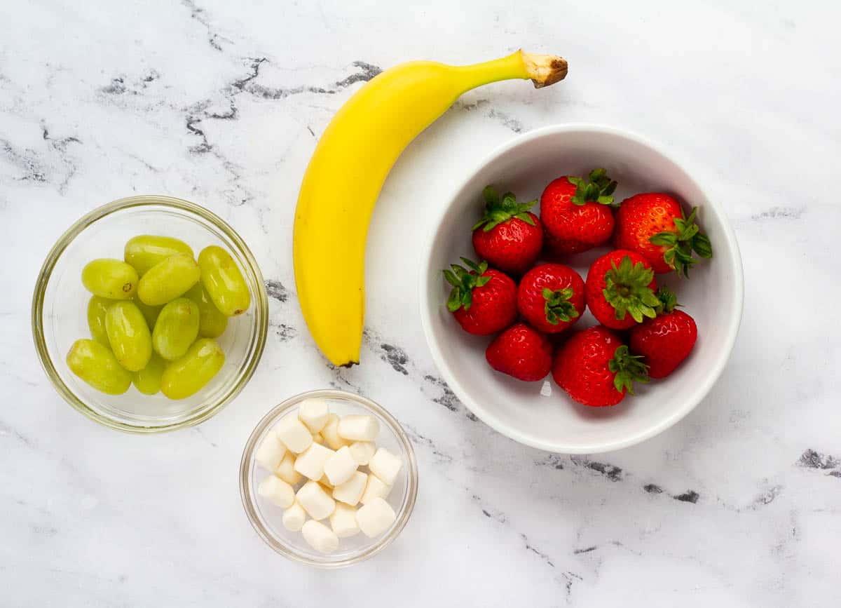 Strawberries, banana, grapes, and marshmallows.

