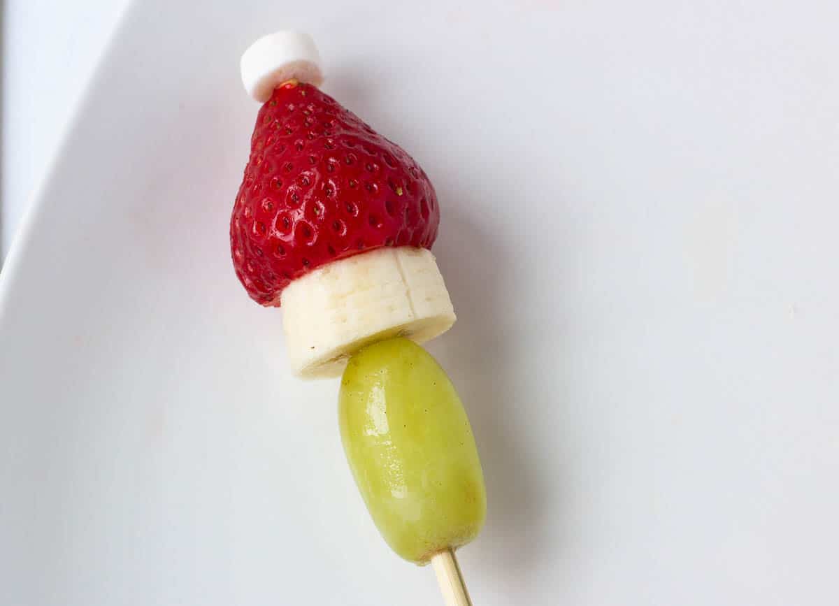 Grape, banana, strawberry, and marshmallow on skewer. 