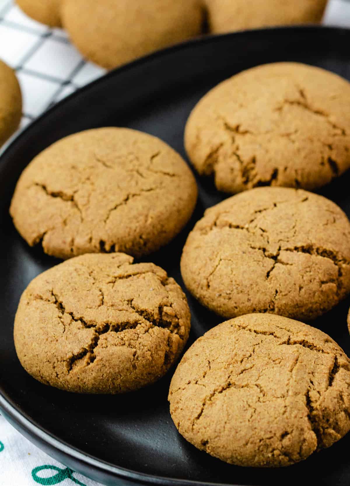 vegan ginger cookies on black plate.
