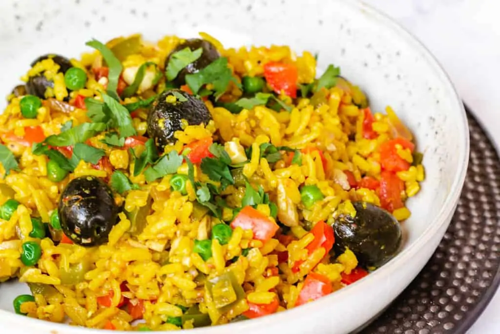vegan paella topped with olives and cilantro