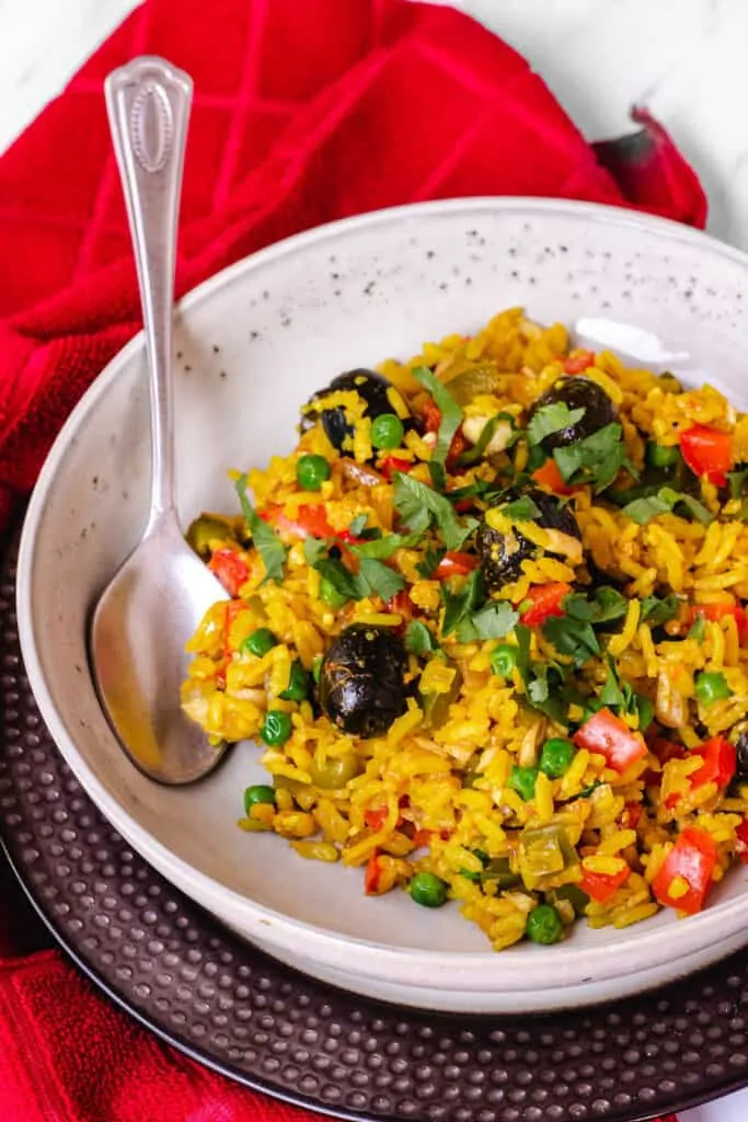 vegan paella with black olives and cliantro