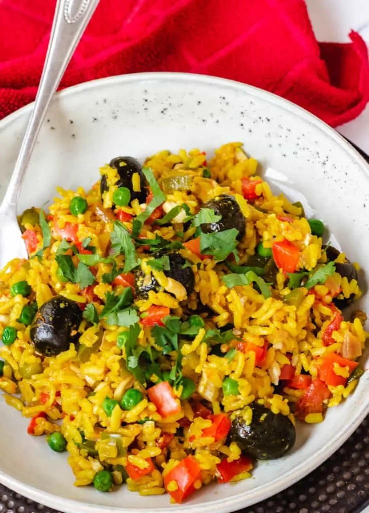 vegetable paella topped with olives and cilantro