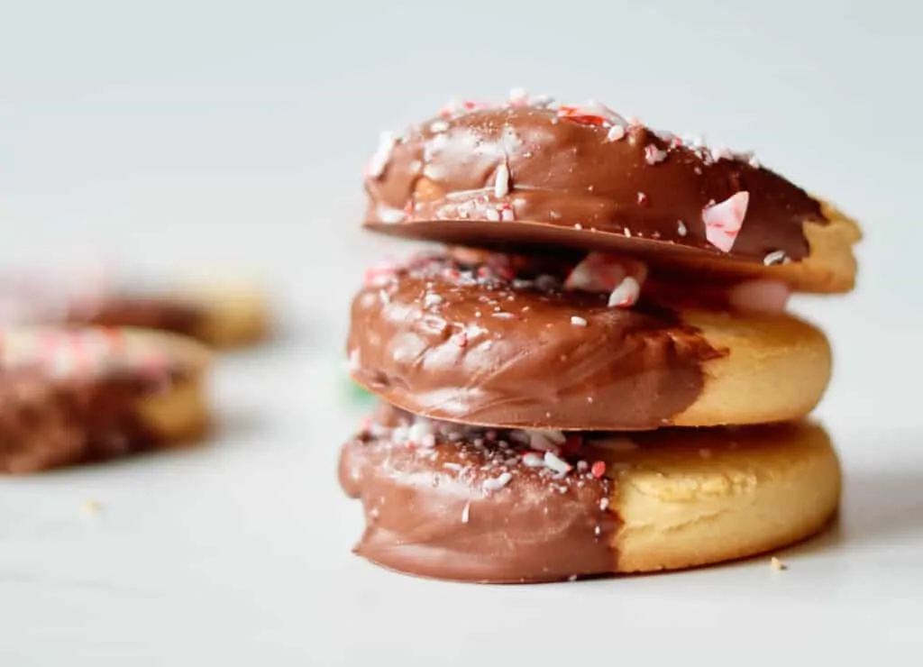 3 vegan shortbread cookies dipped in chocolate stacked on top of one another