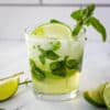 mojito mocktail in rocks glass garnished with mint and lime