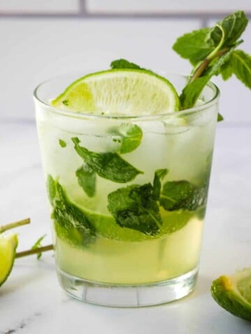 mojito mocktail in rocks glass garnished with mint and lime