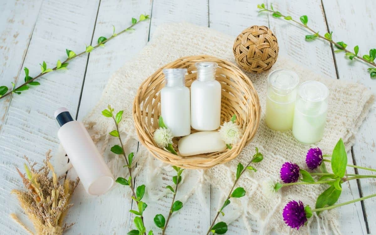 shampoo and conditioner bottles in basket on natural background
