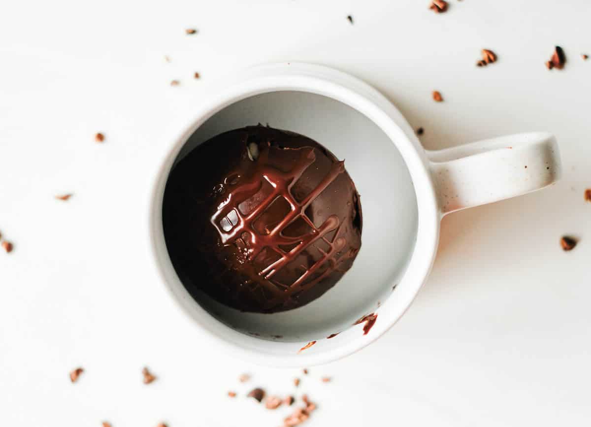 vegan hot chocolate bomb in white mug