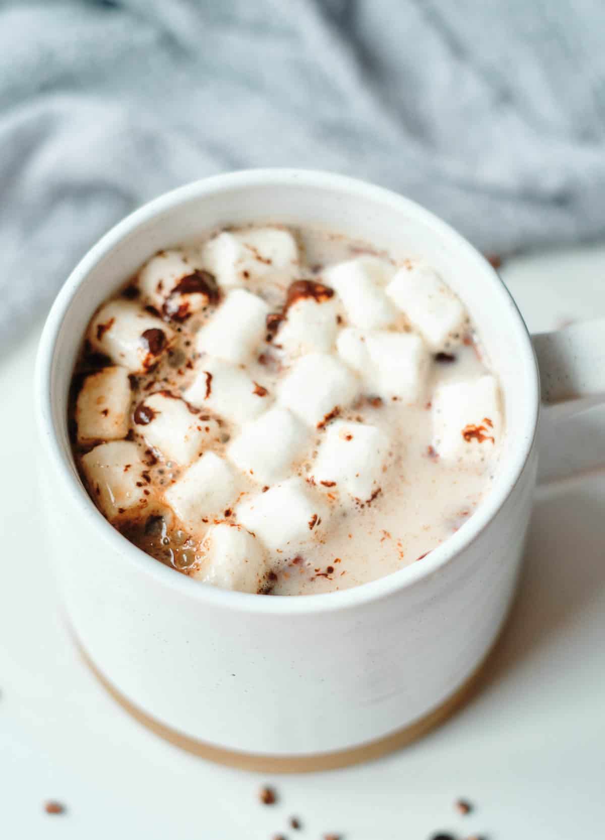 over head close up of hot chocolate in mug topped with marshmallows