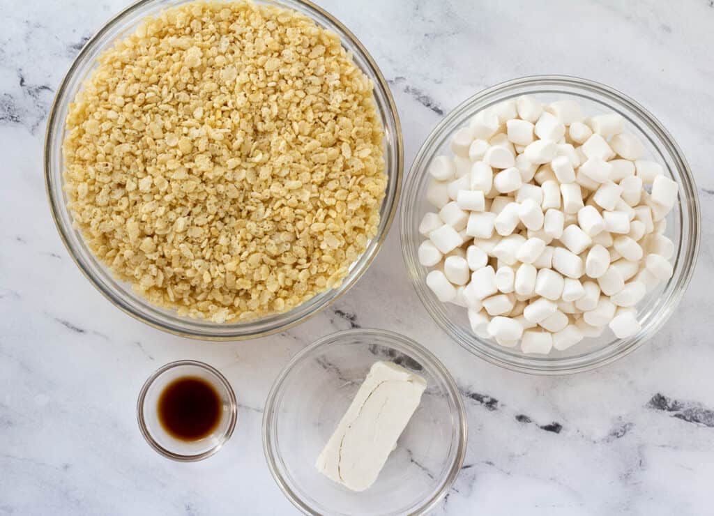 rice cereal, marshmallows, vanilla extract and butter in glass bowls
