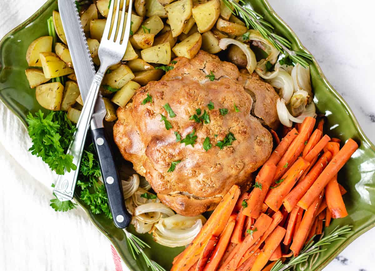 vegan roast dinner with cauliflower, carrots, potatoes, and onions