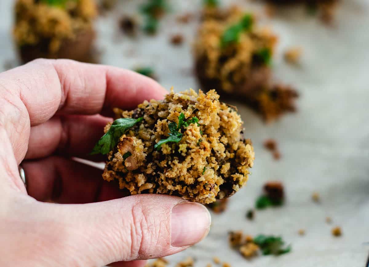 hand holding vegan stuffed mushrooms