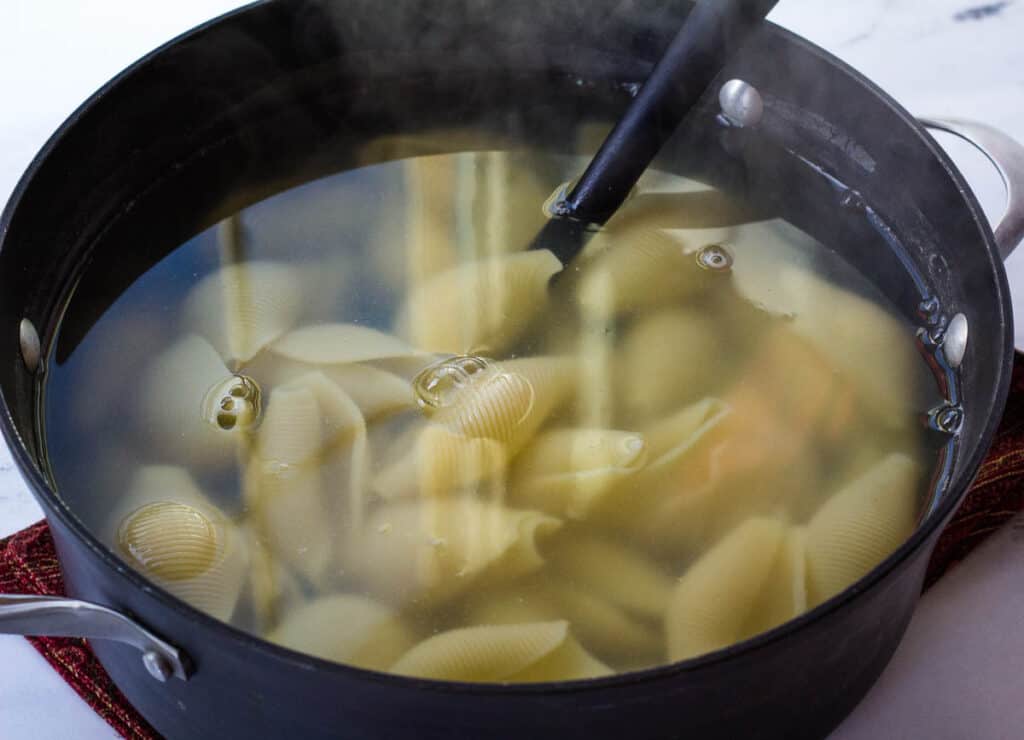 jumbo shells boiling in large pot of water