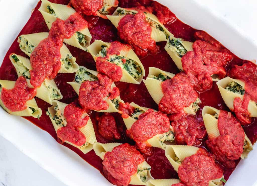 vegan stuffed shells topped with tomato sauce