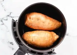 2 sweet potatoes in air fryer basket