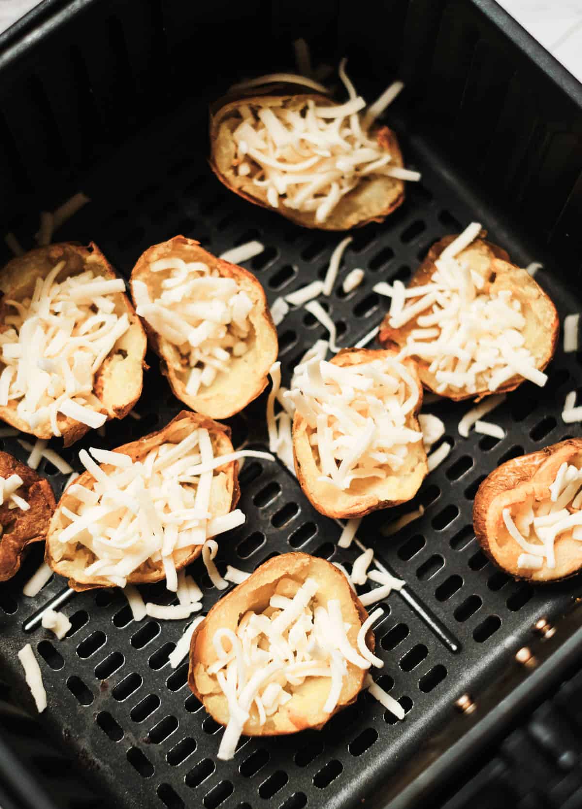 potato skins filled with cheese in air fryer basket