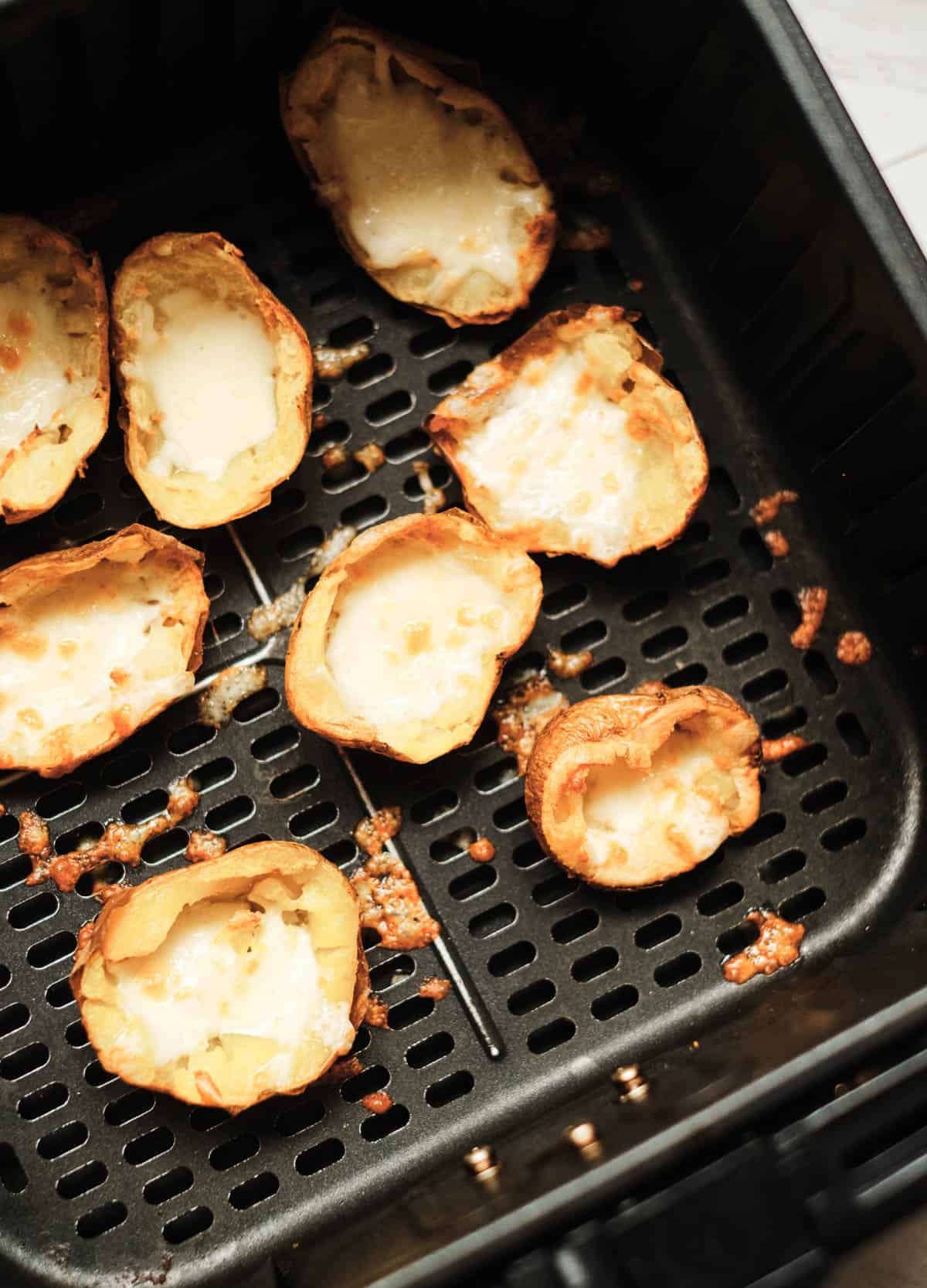 potato skins with melted cheese in air fryer basket