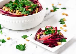 beetroot salad in serving dish, and on small white plate
