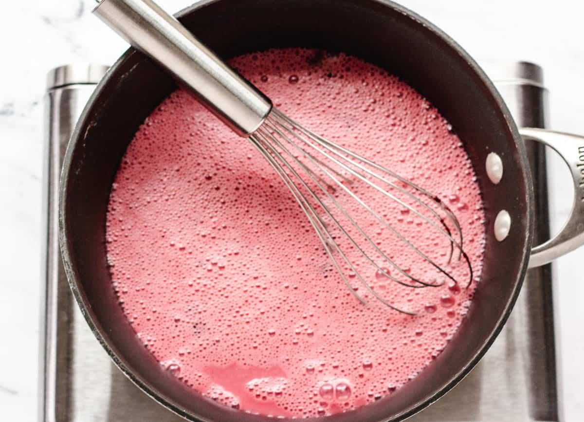 Beet latte milk in saucepan.