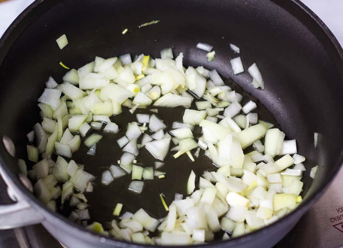 Chopped onions sautéing in saucepan.