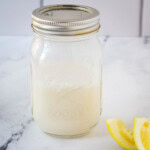vegan buttermilk in mason jar next to lemon slices