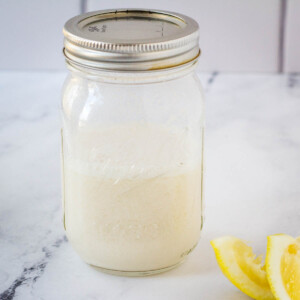 vegan buttermilk in mason jar next to lemon slices
