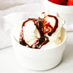 vegan chocolate sauce over vanilla ice cream in white bowl
