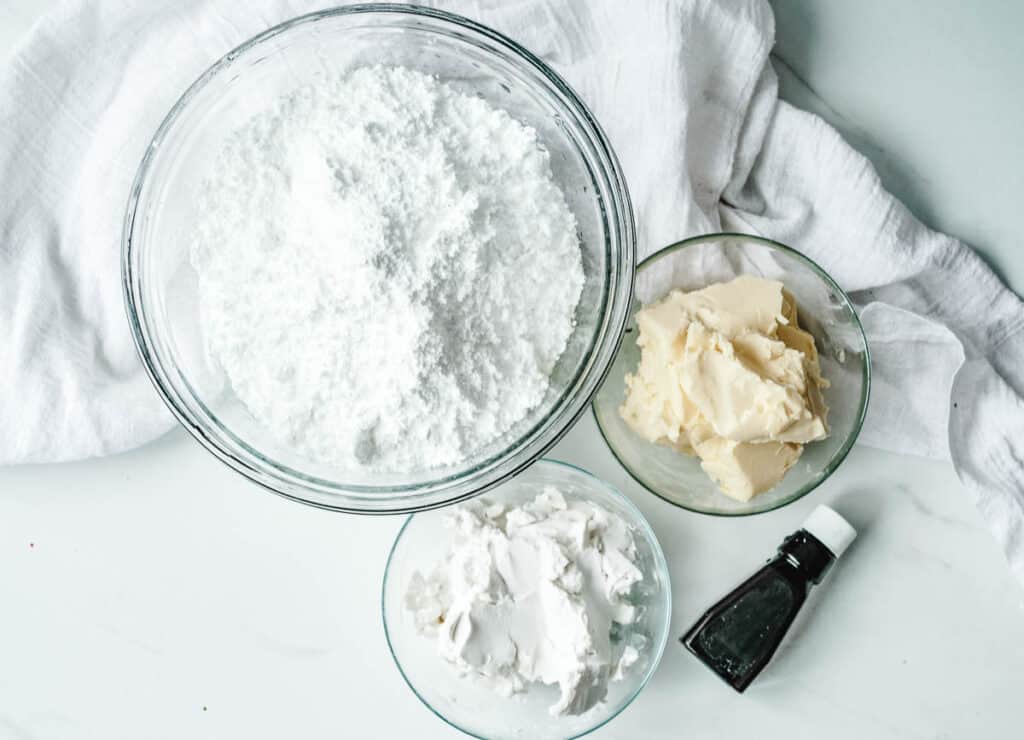 vegan cream cheese frosting ingredients: powdered sugar, vegan butter, cream cheese, and vanilla