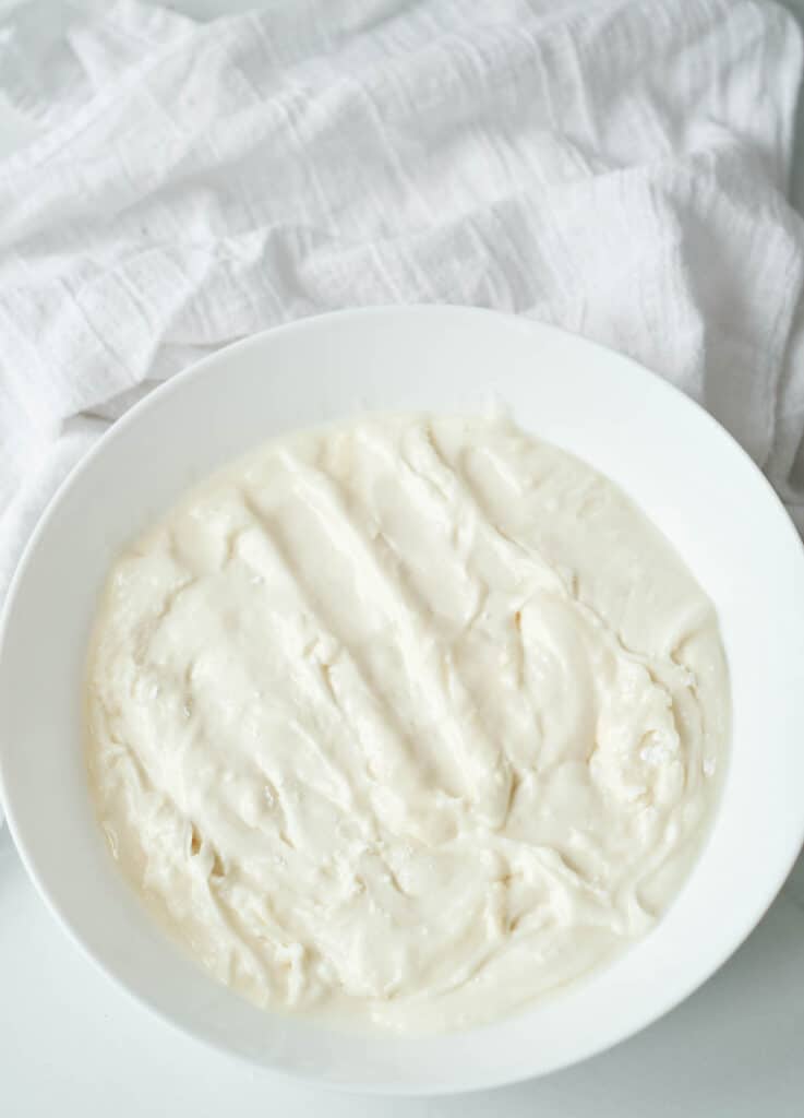 overhead vegan cream cheese frosting in white bowl