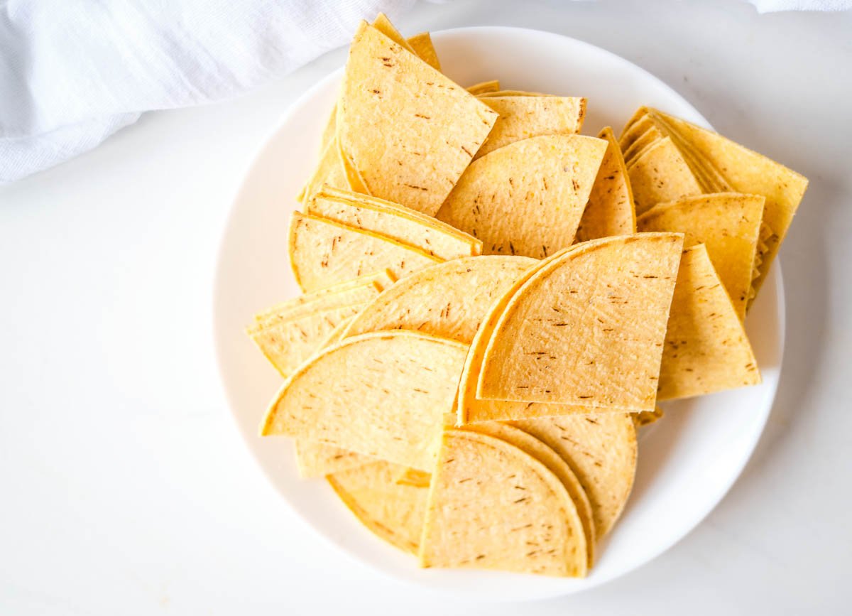 Tortillas cut into triangles and put in a bowl. 
