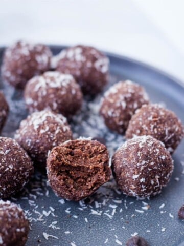 healthy chocolate coconut truffles on gray plate