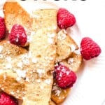 vegan french toast sticks on white plate topped with raspberries