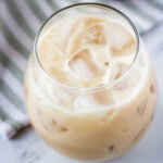 vegan Irish cream in stemless wine glass over ice