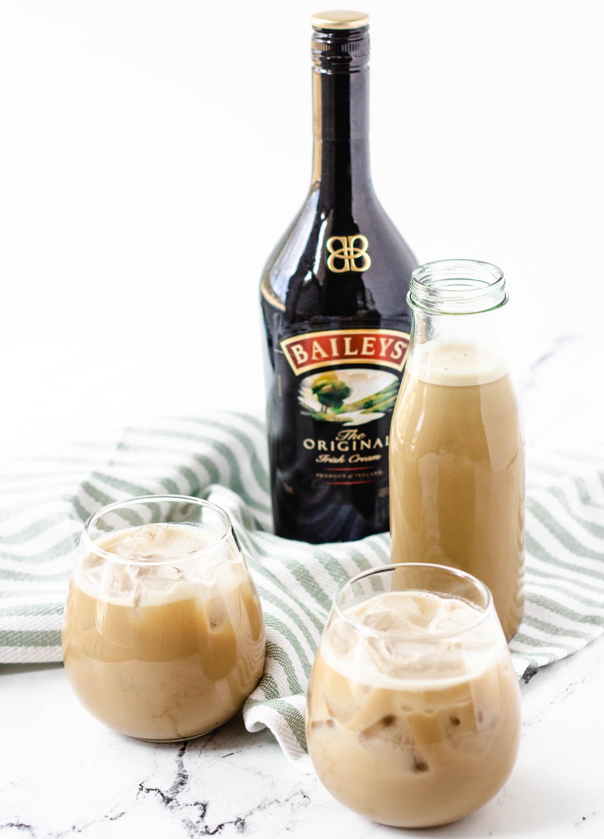 vegan Bailey's Irish cream in stemless wine glasses with Bailey's bottle in the background