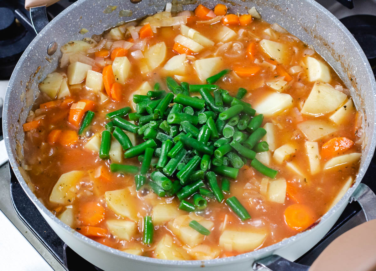 Vegan Irish stew in pot with added green beans.