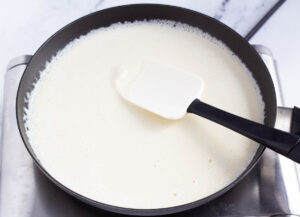 white liquid in small pan with spatula