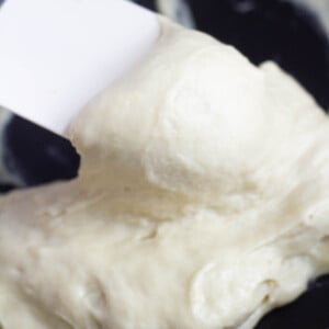 stretchy vegan mozzarella cheese on spatula in pan on