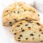 vegan soda bread loaf on wood serving tray with two slices