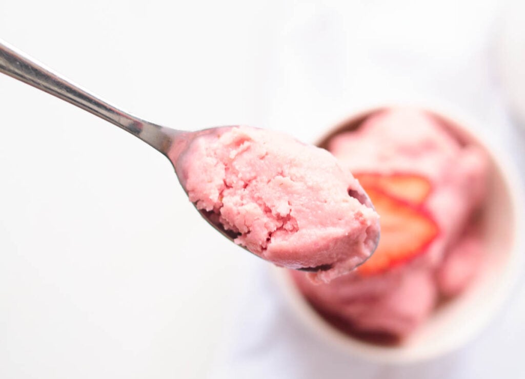 vegan strawberry ice cream on a spoon