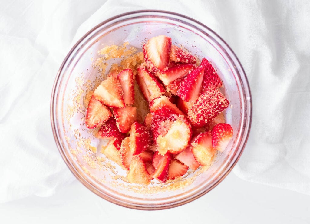 strawberries, sugar, and lemon juice in glass bowl
