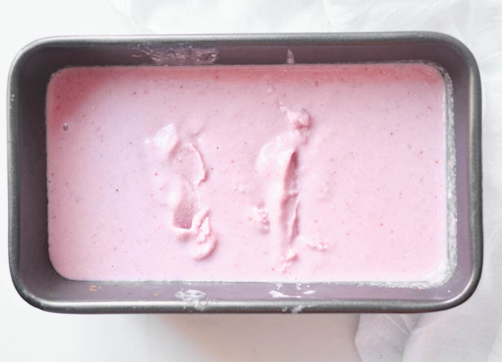 strawberry ice cream in creamy soft serve like consistency in loaf pan